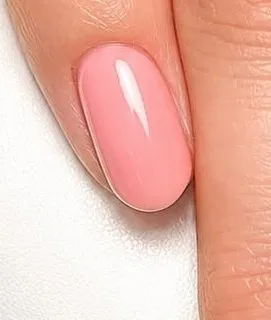 A glossy coral-pink gel nail, almond shape